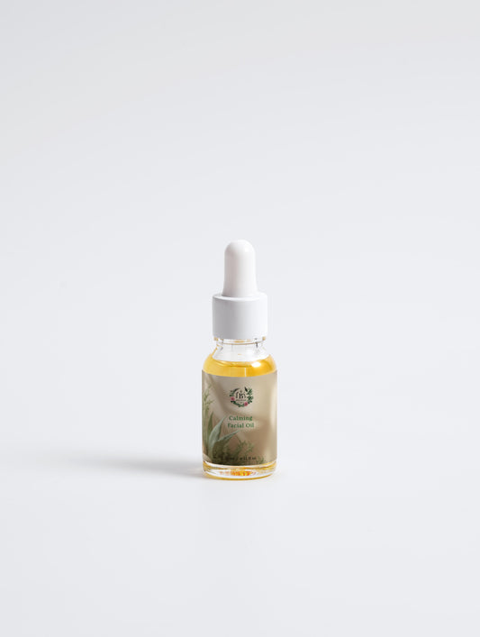 Bottle of essential oil with dropper on a light gray background