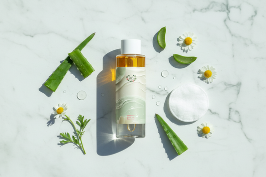 A botanical premium luxury cleanser surrounded by botanical herbs.