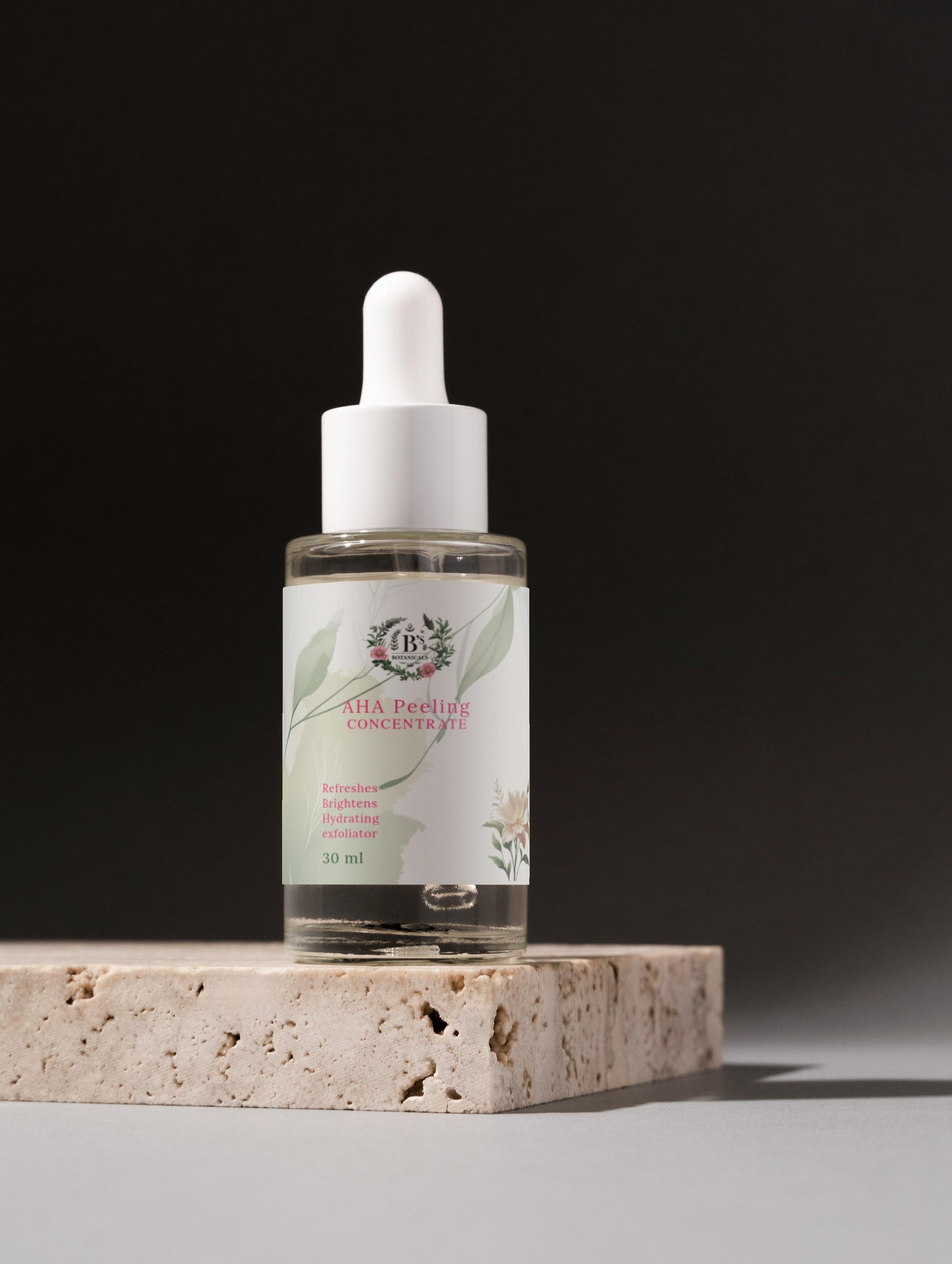 Bottle of skincare serum with dropper on a stone surface against a dark background