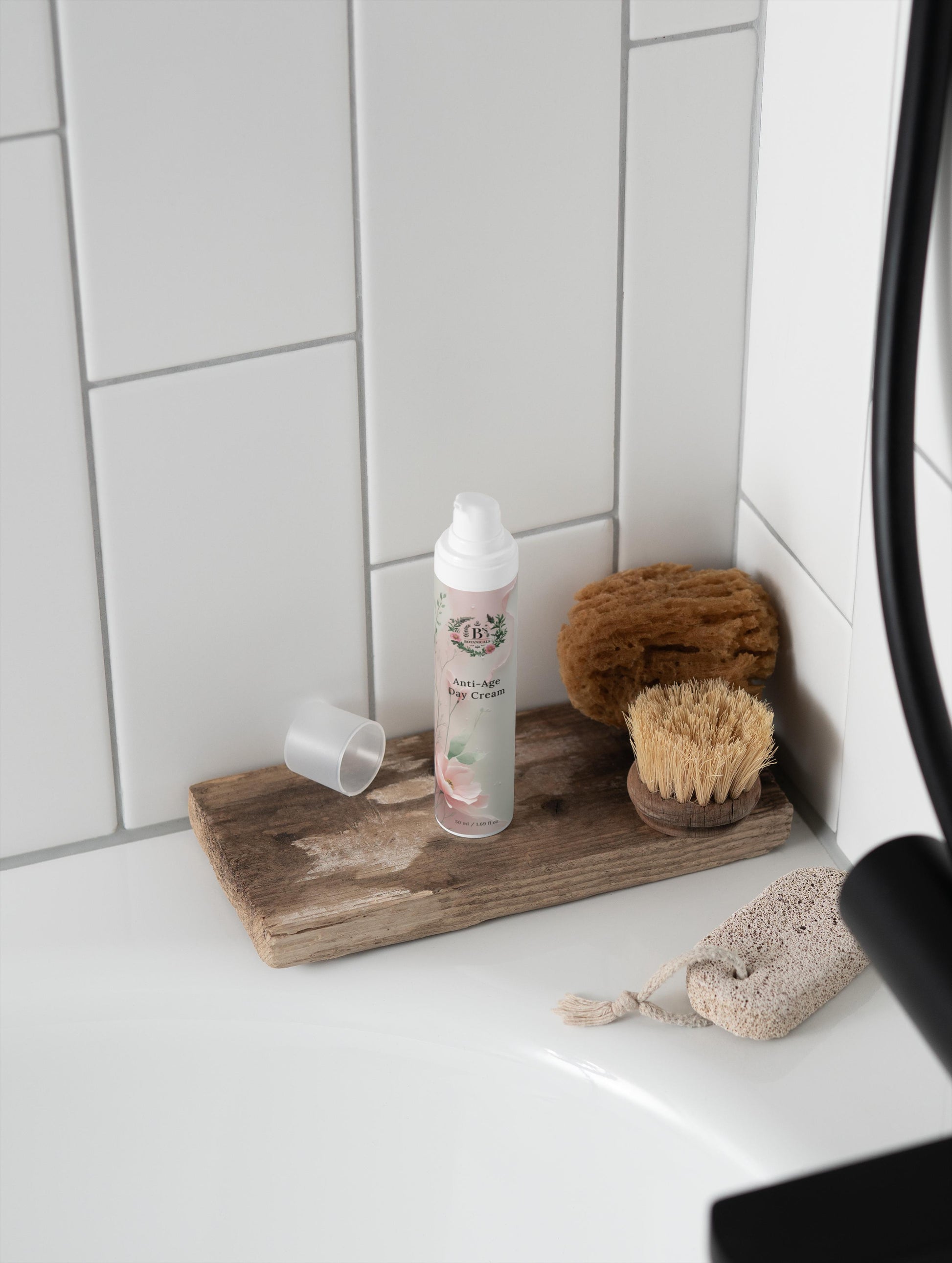 Cleaning supplies including a spray bottle, sponges, and a scrubber on a wooden tray in a bathroom.