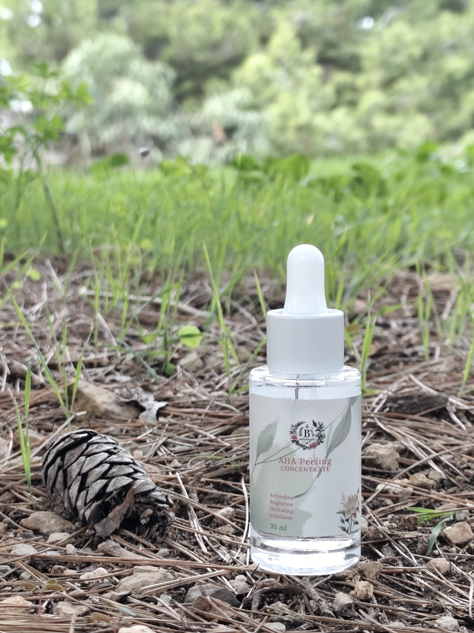 Bottle with dropper on a natural background