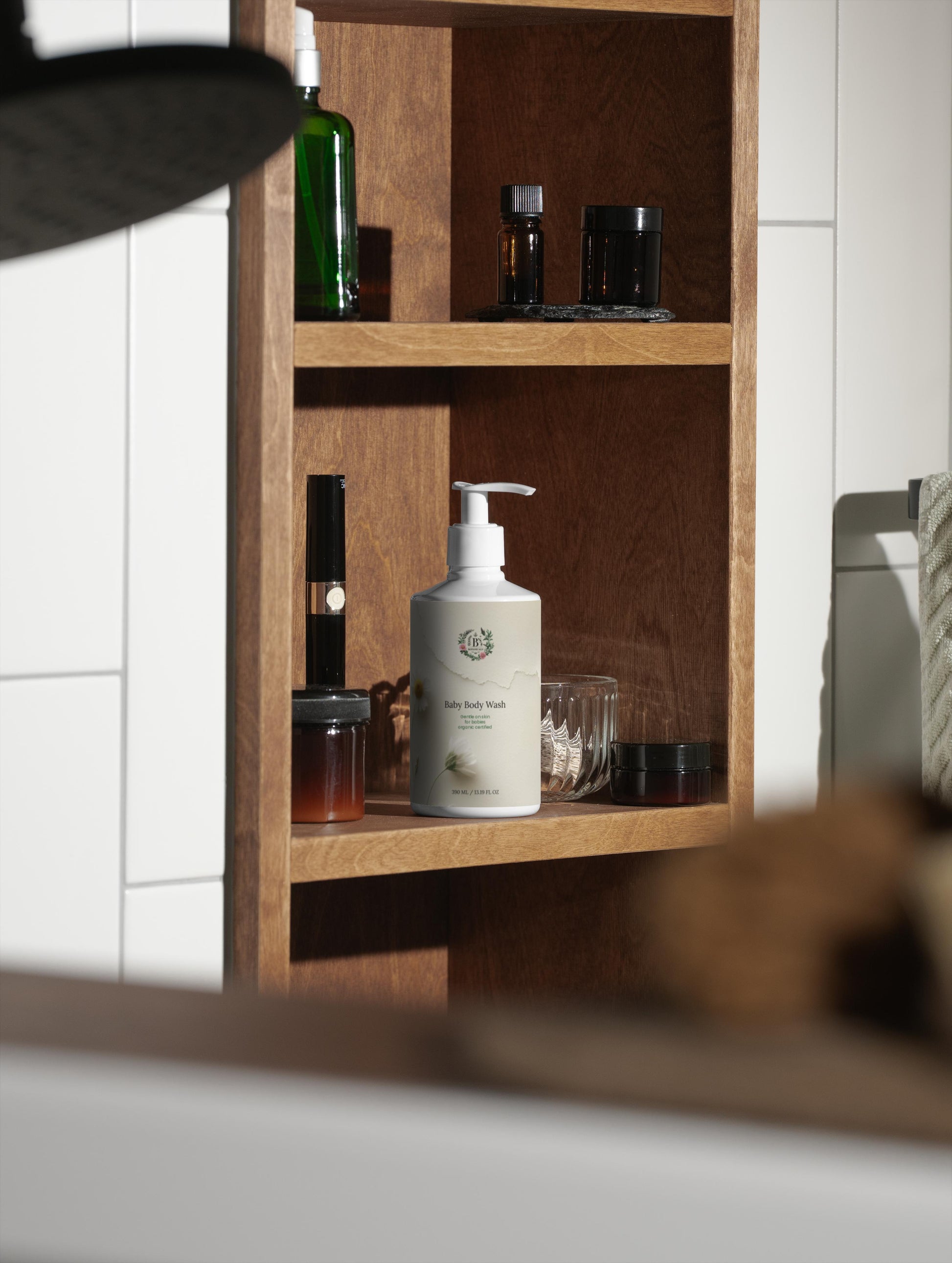 Wooden shelf with various bottles and a pump bottle labeled 'RUM' in a bathroom setting.