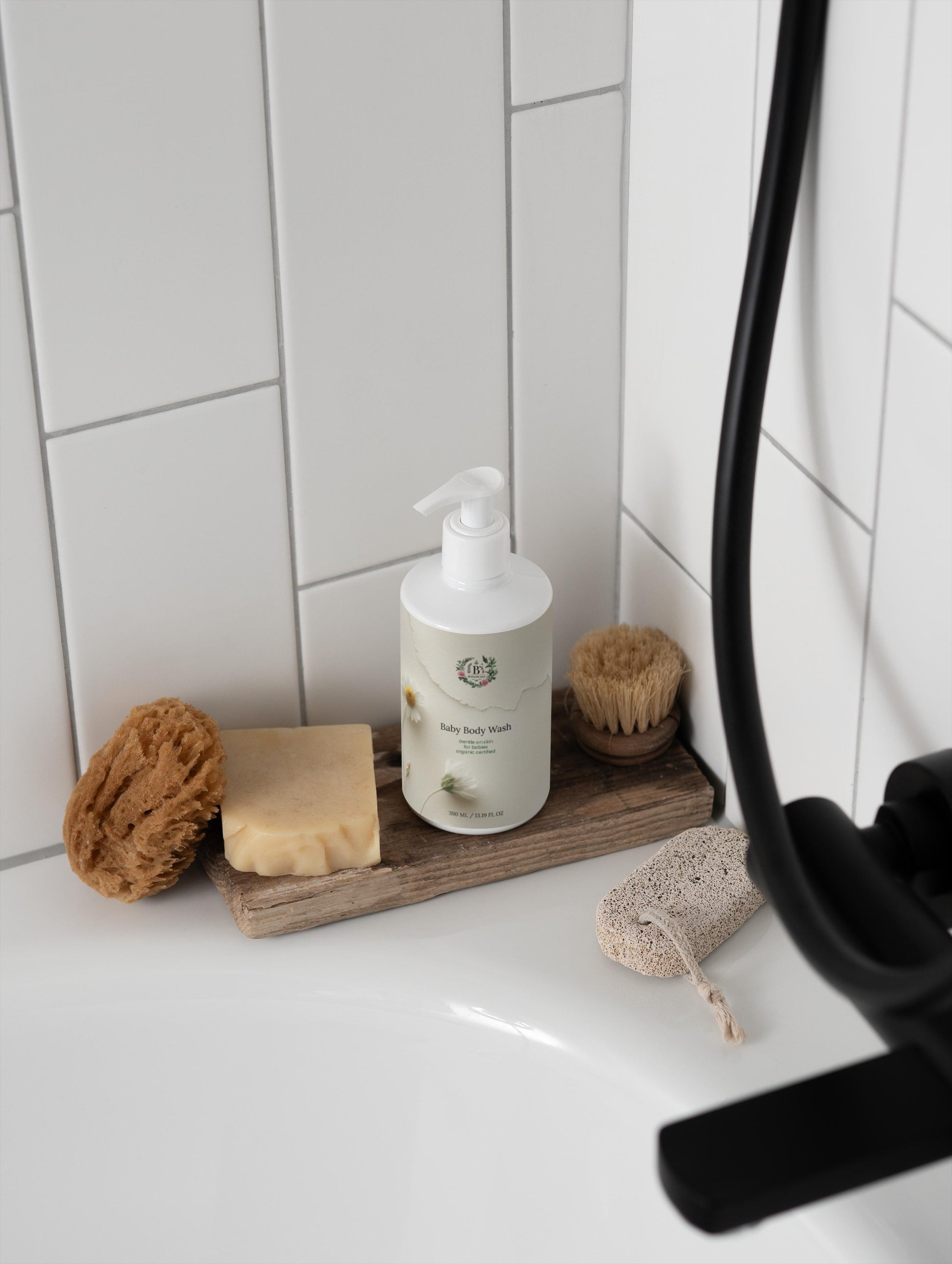 Bathroom counter with soap, scrubber, and bottle of shampoo on a wooden tray.