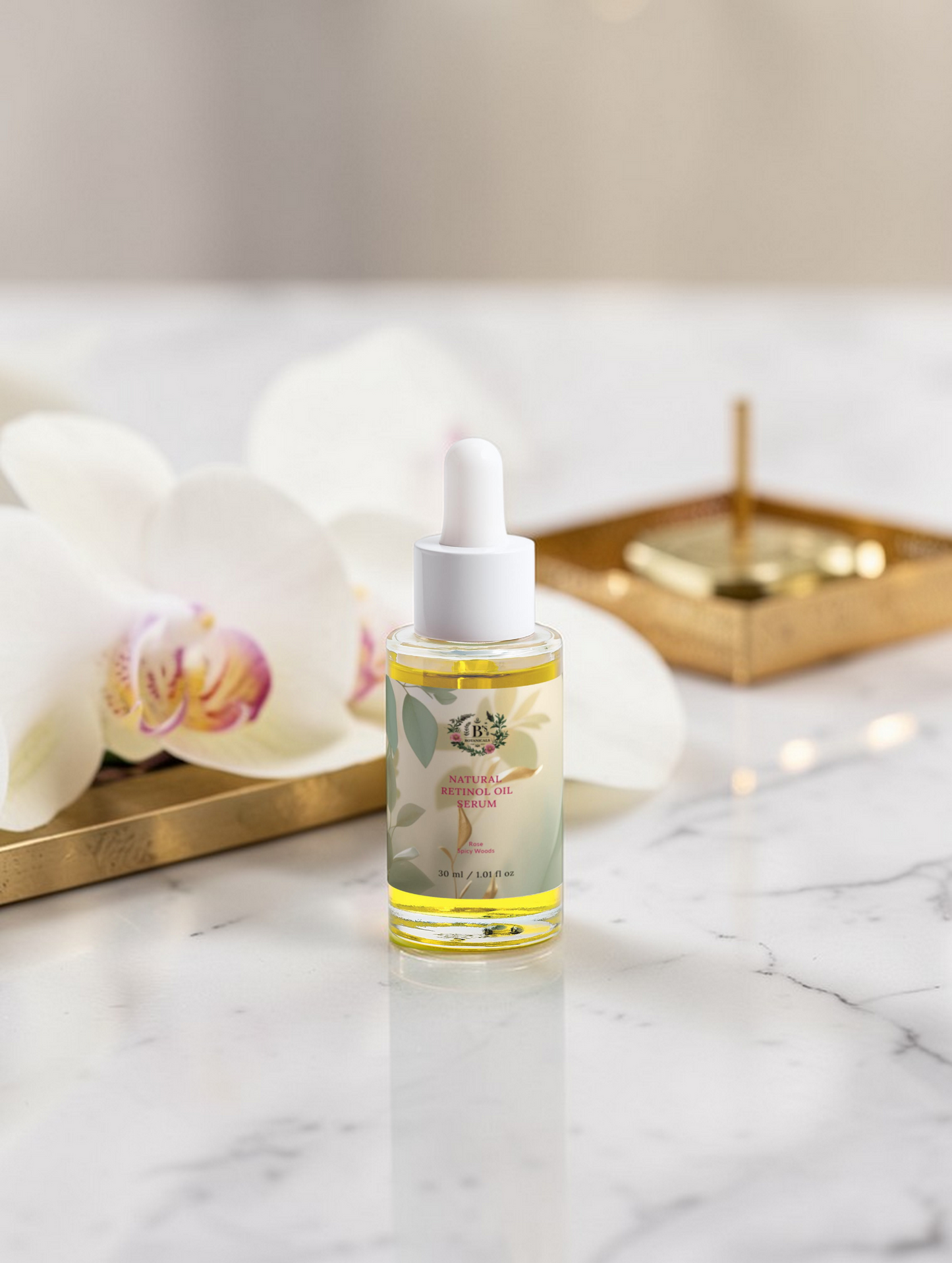 Bottle of skincare serum on a marble surface with decorative elements
